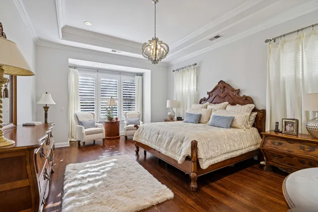 a living room with lots of furniture a rug and a large window