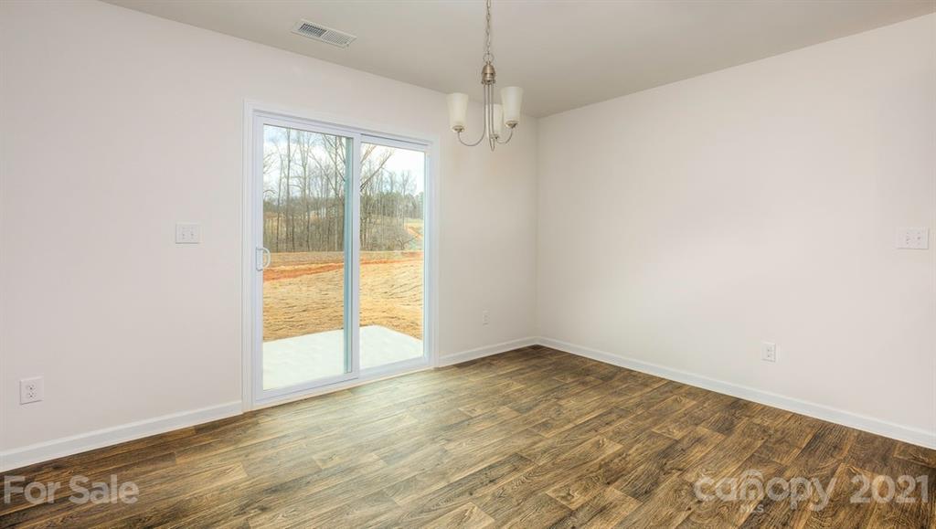 348 Gaines Road Clover, SC 29710 - Photo 12 of 48 an empty room with wooden floor and windows
