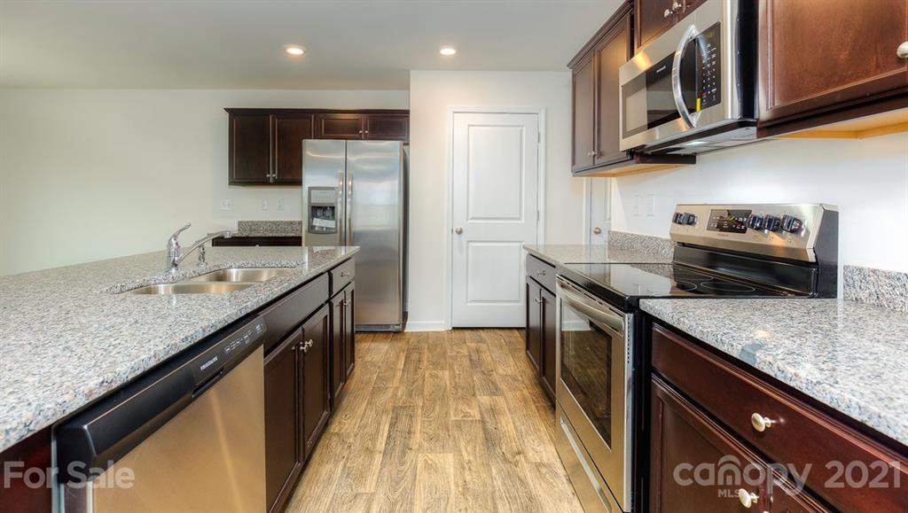 348 Gaines Road Clover, SC 29710 - Photo 22 of 48 a kitchen with granite countertop stainless steel appliances and wooden cabinets