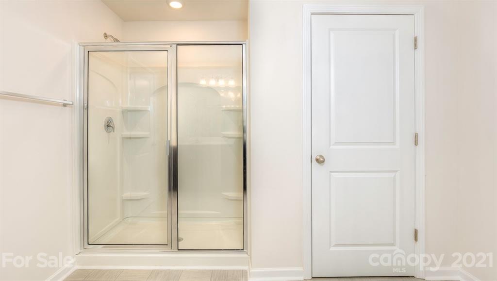 348 Gaines Road Clover, SC 29710 - Photo 25 of 48 a bathroom with a glass shower door