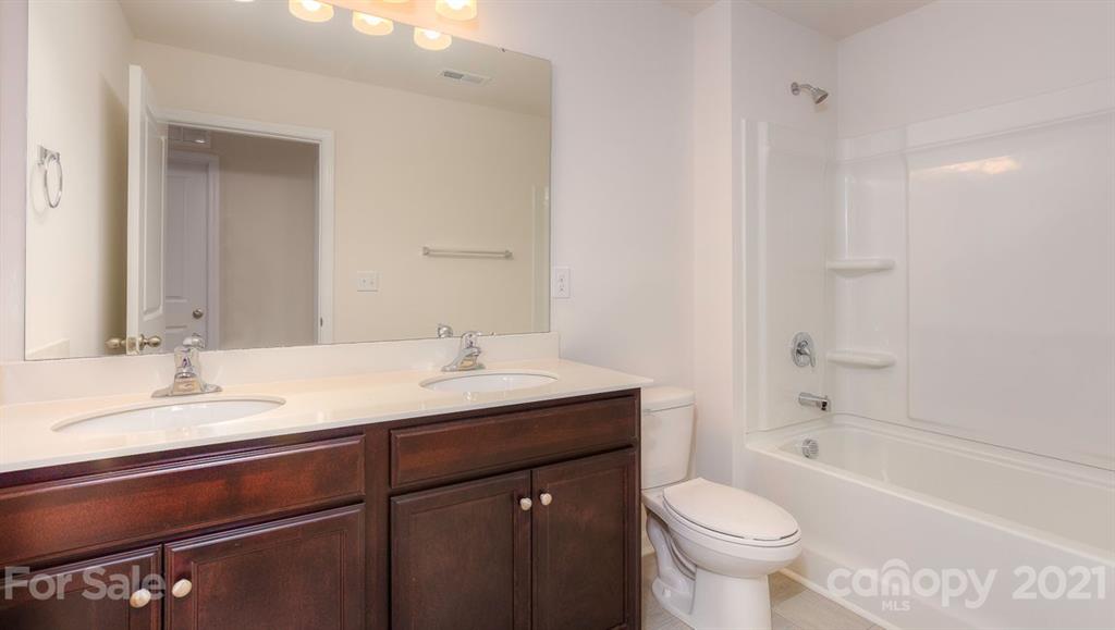 348 Gaines Road Clover, SC 29710 - Photo 4 of 48 a bathroom with a sink double vanity granite toilet and a bathtub