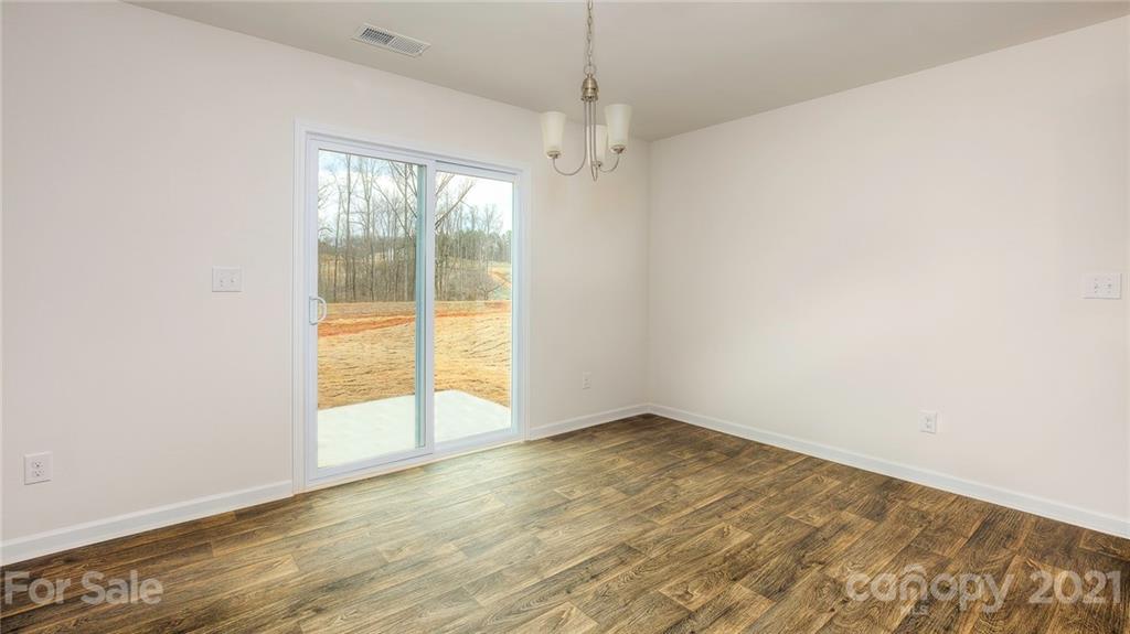 348 Gaines Road Clover, SC 29710 - Photo 40 of 48 an empty room with wooden floor and windows