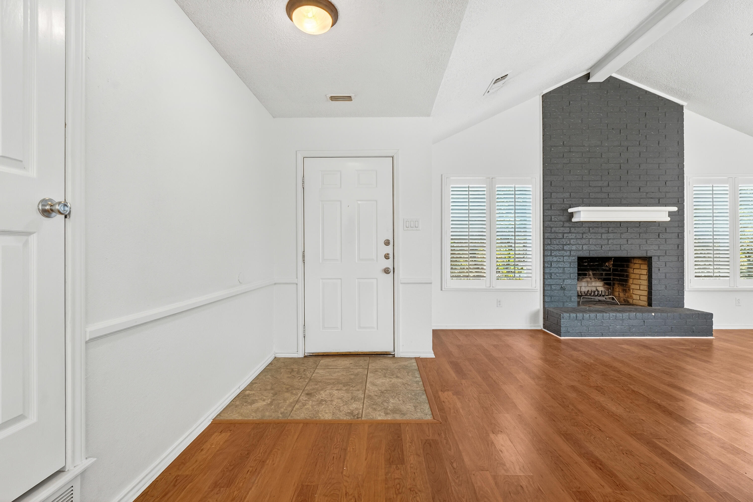 5221 84th Street Lubbock, TX 79424 - Photo 3 of 26 a view of empty room with wooden floor and fireplace