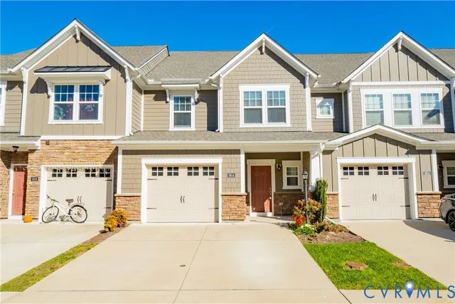 a view of a white house with large windows next to a road