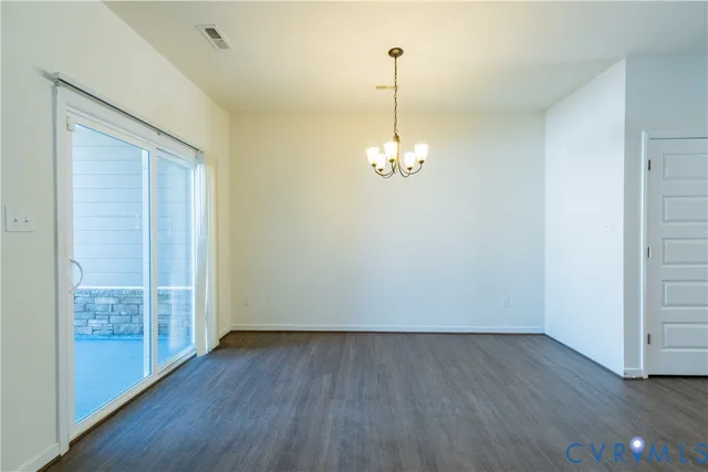 a large kitchen with a wooden floor and a sink