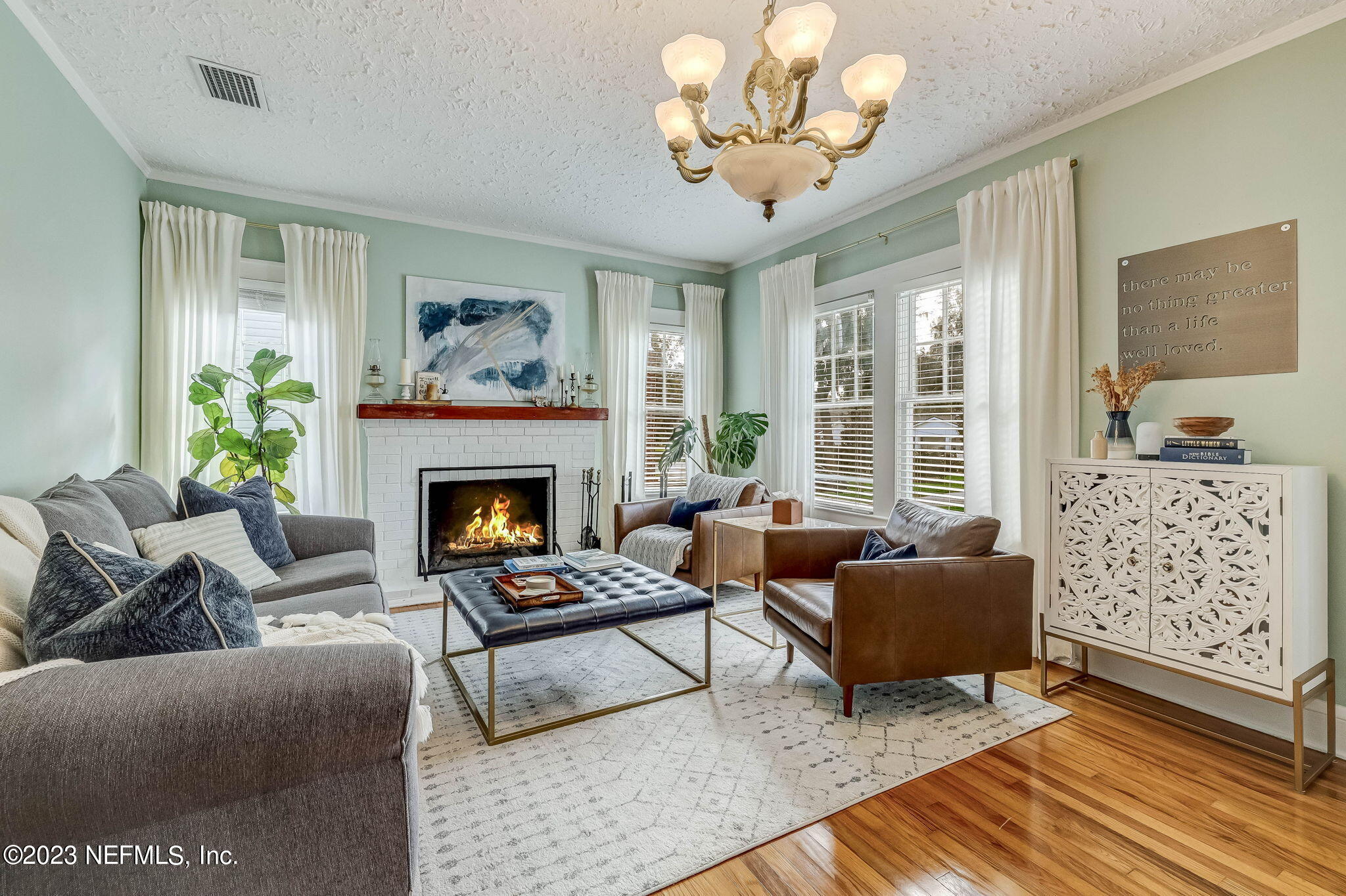 1515 Mayfair Road Jacksonville, FL 32207 - Photo 11 of 52 a living room with furniture a chandelier and a fireplace