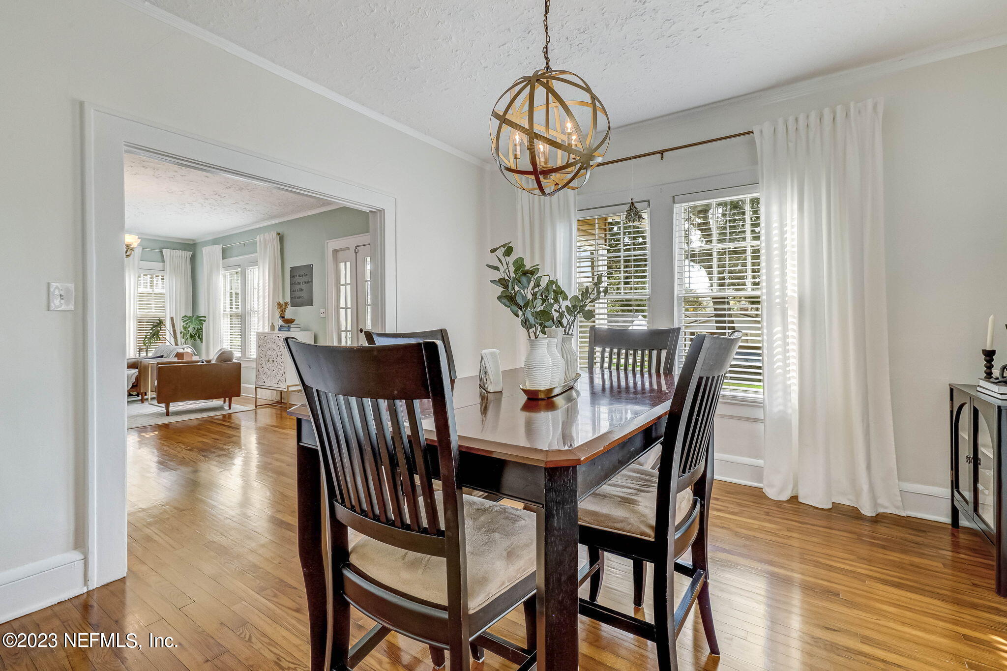 1515 Mayfair Road Jacksonville, FL 32207 - Photo 16 of 52 a view of a dining room with furniture wooden floor and chandelier