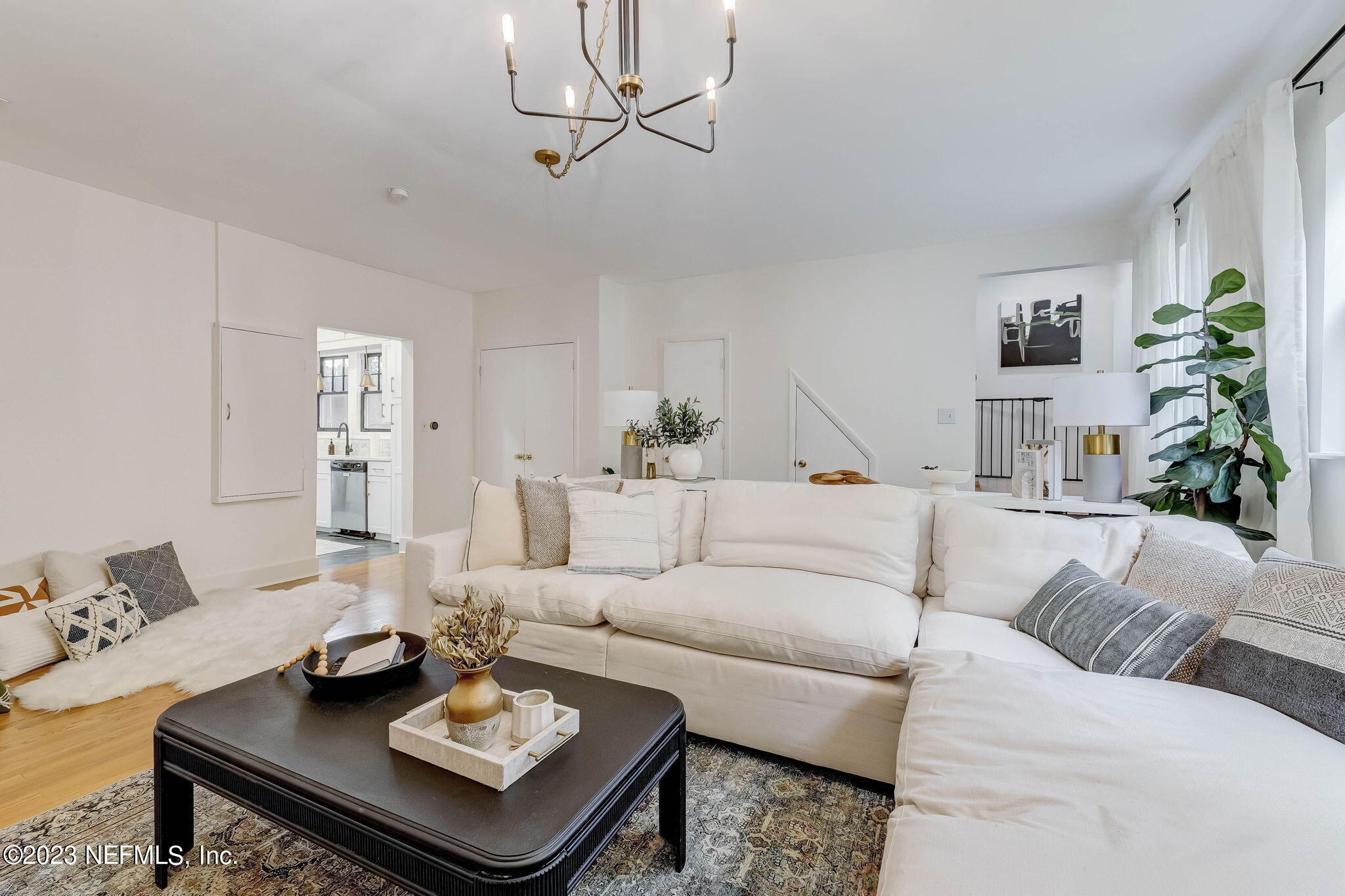 1515 Mayfair Road Jacksonville, FL 32207 - Photo 21 of 52 a living room with furniture a rug and a chandelier