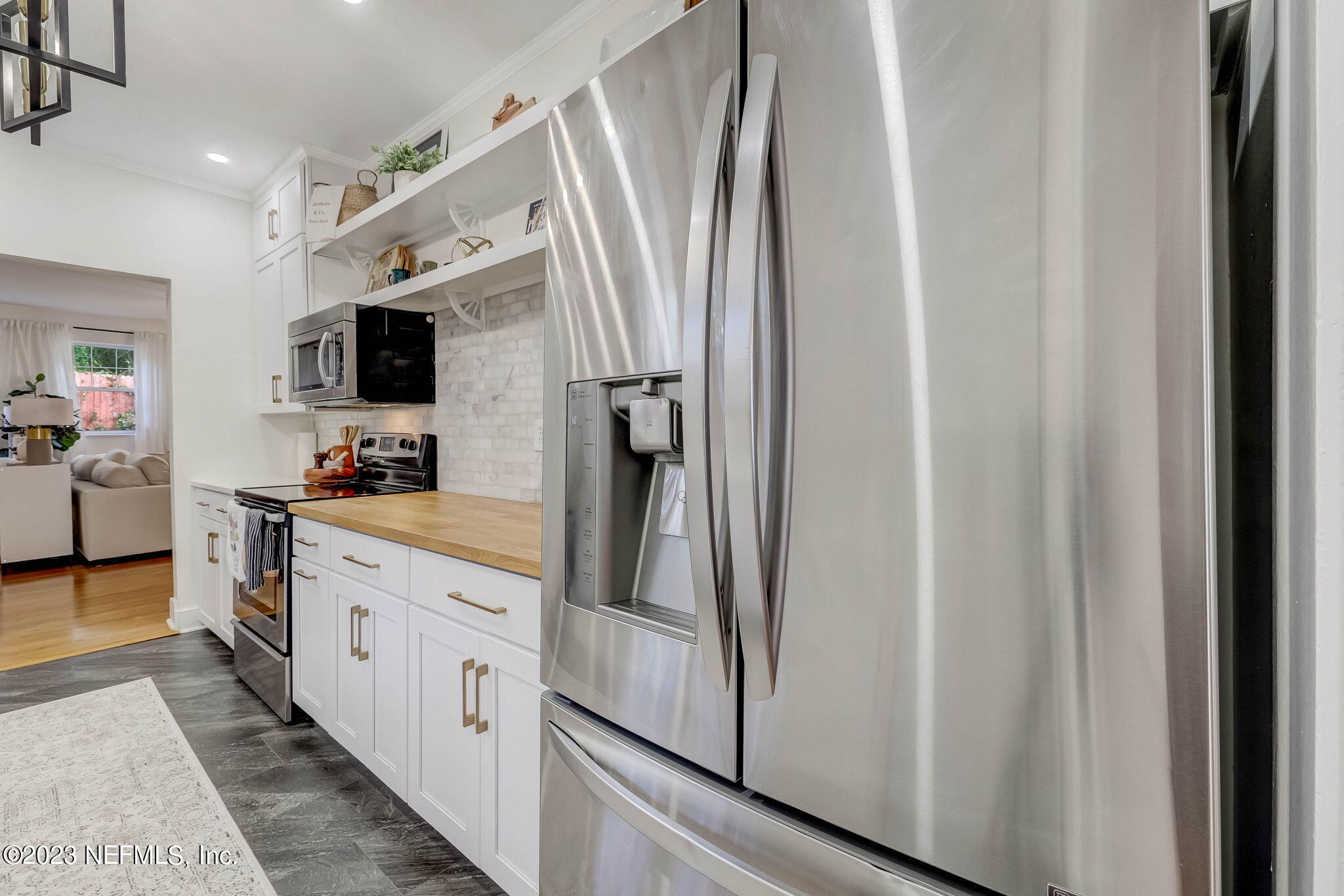 1515 Mayfair Road Jacksonville, FL 32207 - Photo 25 of 52 a large white kitchen with stainless steel appliances granite countertop a refrigerator and a sink