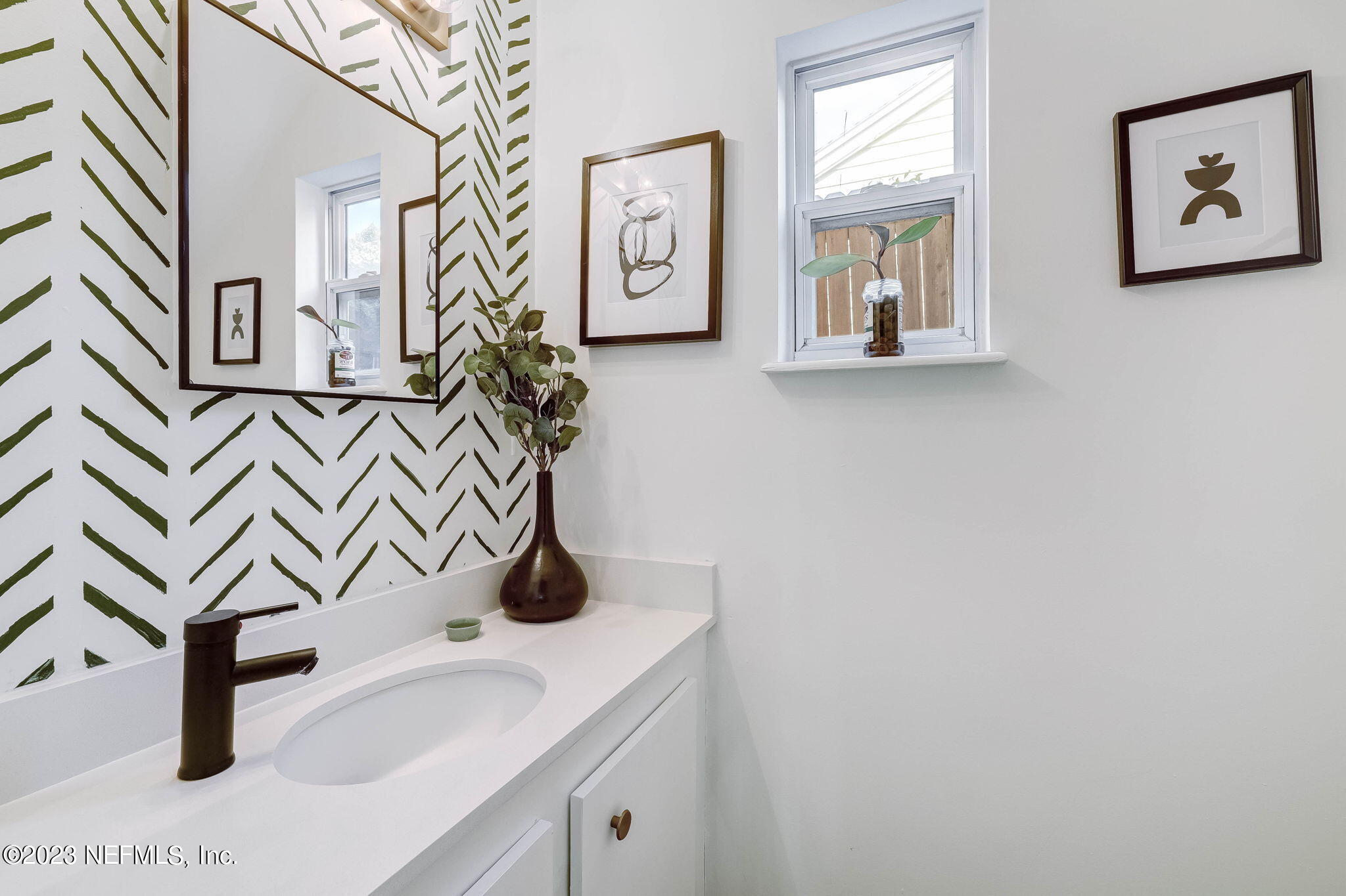 1515 Mayfair Road Jacksonville, FL 32207 - Photo 30 of 52 a bathroom with a sink and a mirror