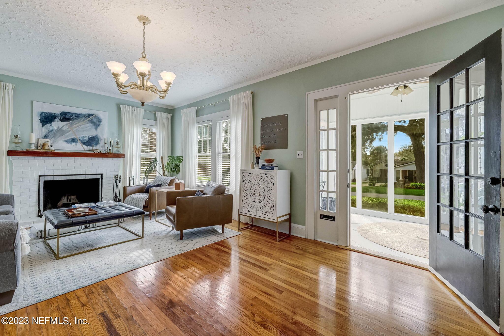1515 Mayfair Road Jacksonville, FL 32207 - Photo 9 of 52 a living room with furniture a chandelier and a fireplace