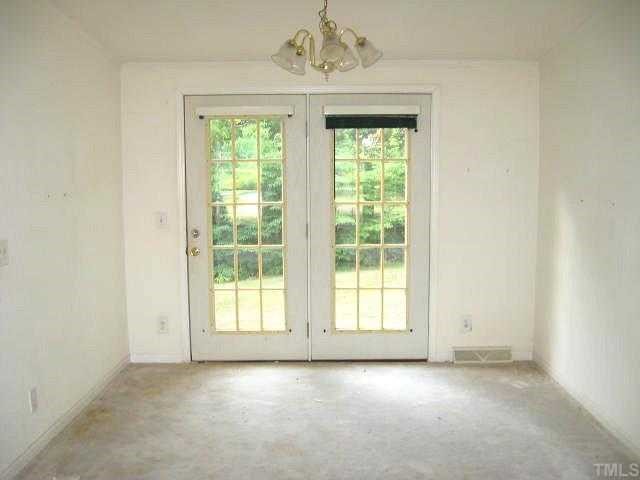 560 Pixley Pritchard Road Timberlake, NC 27583 - Photo 3 of 12 an empty room with a window