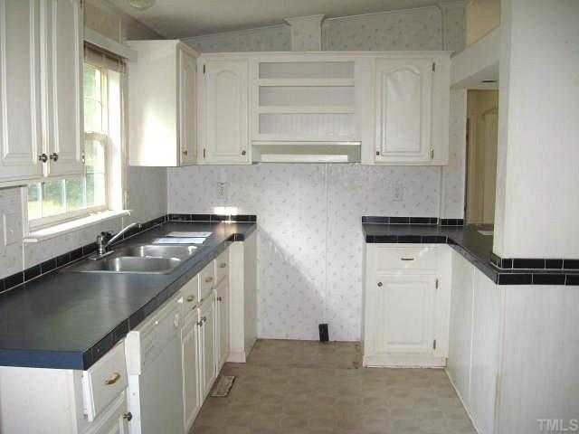 560 Pixley Pritchard Road Timberlake, NC 27583 - Photo 4 of 12 a kitchen with granite countertop a sink and a stove