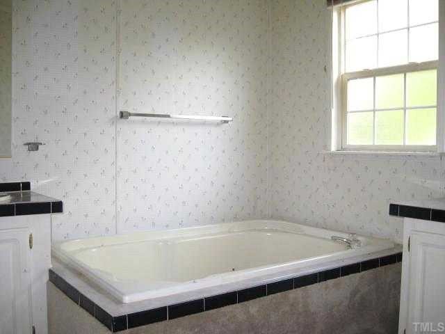 560 Pixley Pritchard Road Timberlake, NC 27583 - Photo 6 of 12 a bathroom with a bath tub and a sink