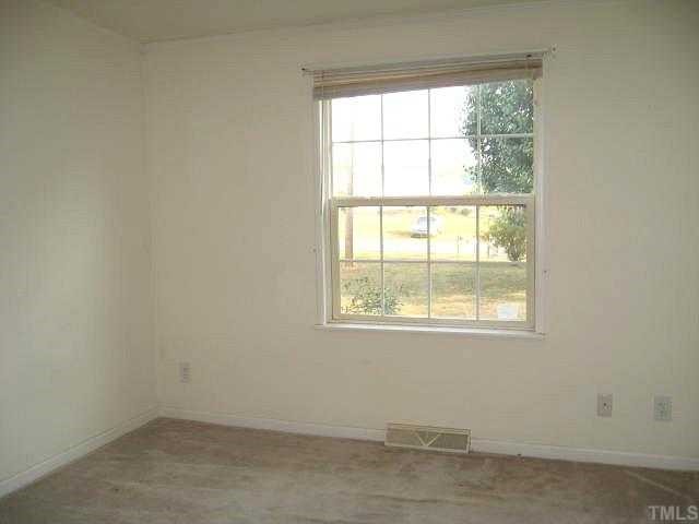 560 Pixley Pritchard Road Timberlake, NC 27583 - Photo 7 of 12 an empty room with a window