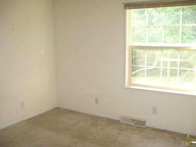 560 Pixley Pritchard Road Timberlake, NC 27583 - Photo 9 of 12 an empty room with a window