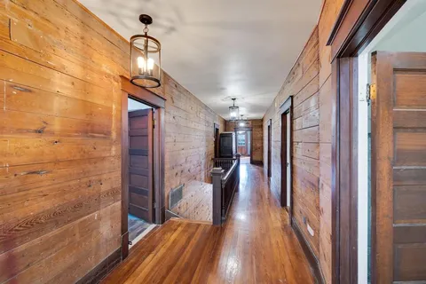 a view of hallway with wooden floor