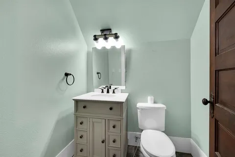 a bathroom with a toilet sink and mirror
