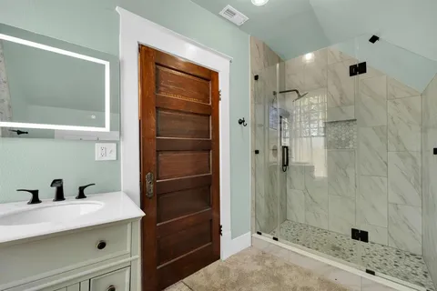 a bathroom with a shower and a sink
