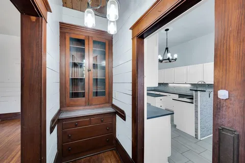 a kitchen with a refrigerator and cabinets