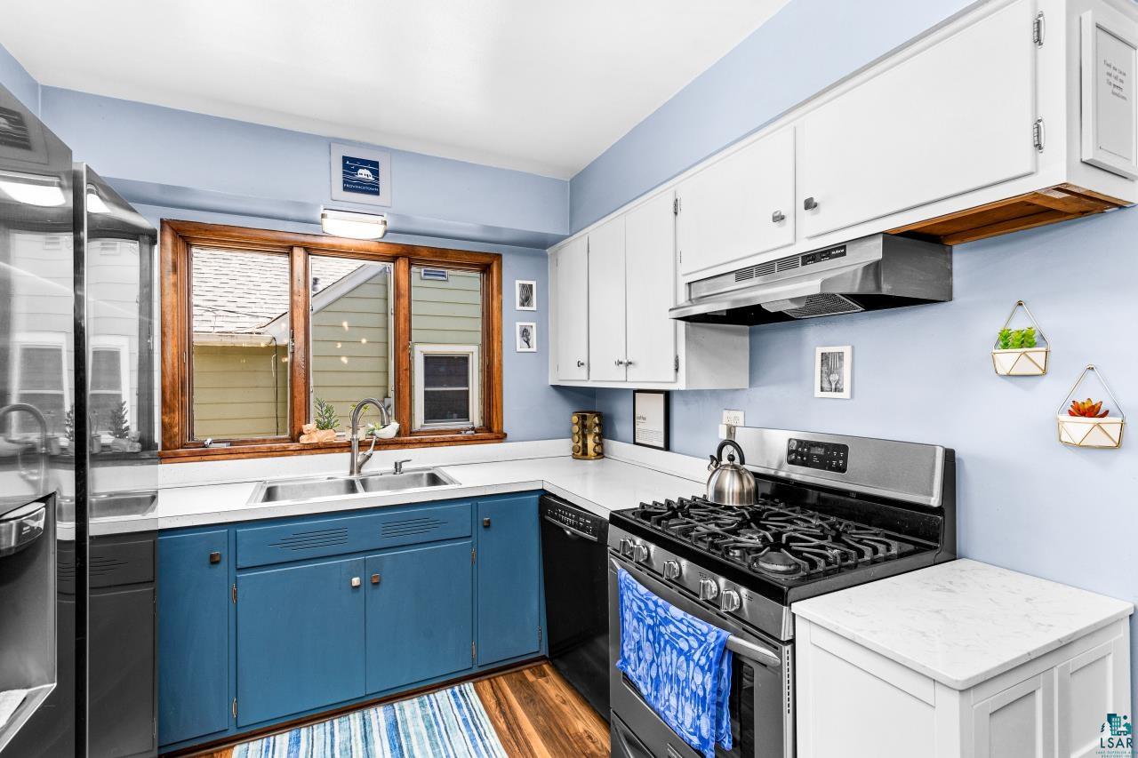 4119 Pitt Street Duluth, MN 55804 - Photo 11 of 50 Kitchen featuring a stainless steel gas range, white upper cabinetry, and blue lower cabinetry