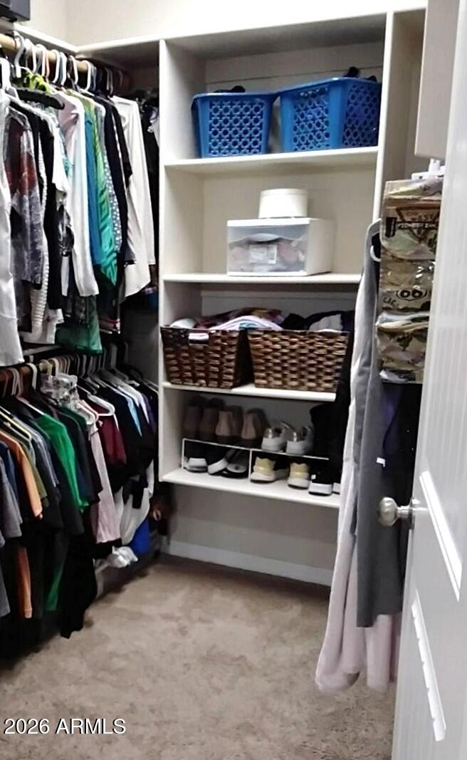 4143 North Stampede Road Kingman, AZ 86401 - Photo 16 of 28 a view of walk in closet with clothes and shoes