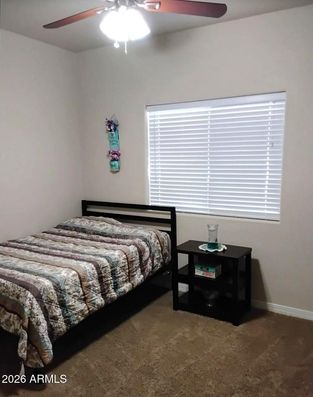 4143 North Stampede Road Kingman, AZ 86401 - Photo 17 of 28 a bedroom with a bed and a window