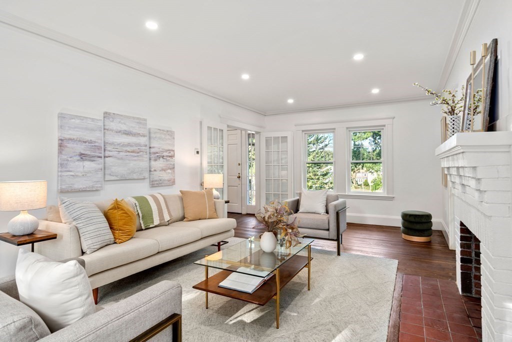 4 Clement Avenue Boston, MA 02132 - Photo 14 of 39 a living room with furniture a fireplace and a large window