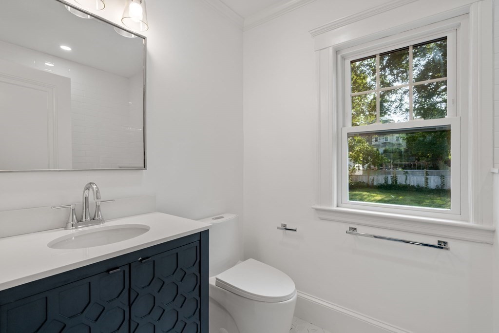 4 Clement Avenue Boston, MA 02132 - Photo 23 of 39 a bathroom with a sink vanity mirror and toilet