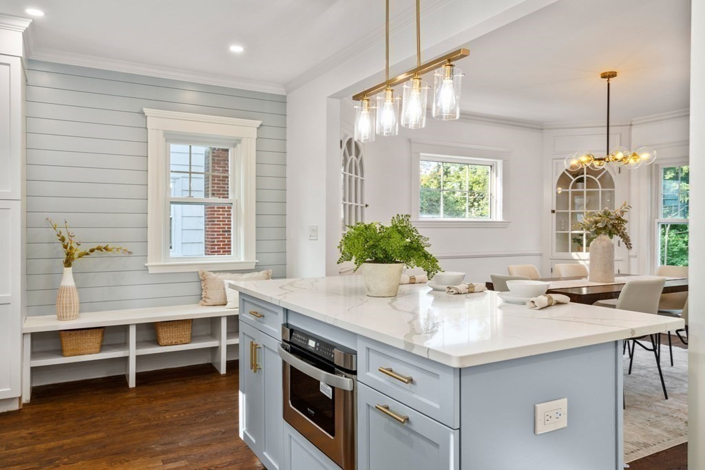 4 Clement Avenue Boston, MA 02132 - Photo 3 of 39 a kitchen that has a sink a stove and a table in it