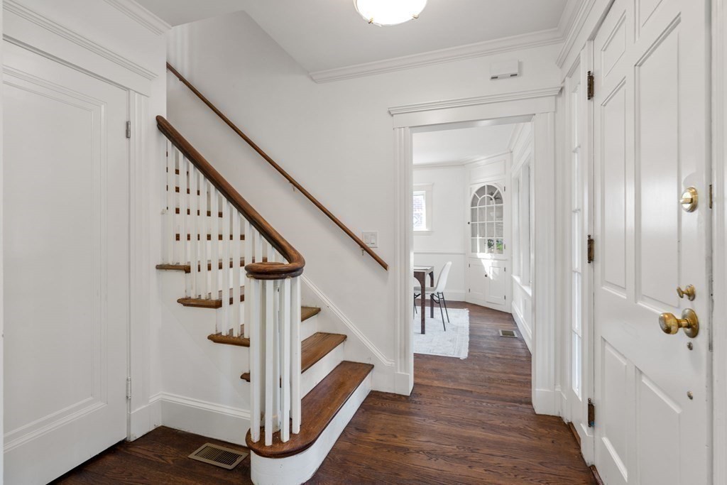 4 Clement Avenue Boston, MA 02132 - Photo 7 of 39 a view of entryway with wooden floor and stairs