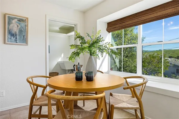 a view of a dining room with furniture and window