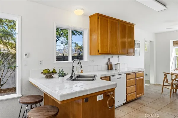 a kitchen with a sink cabinets and a table