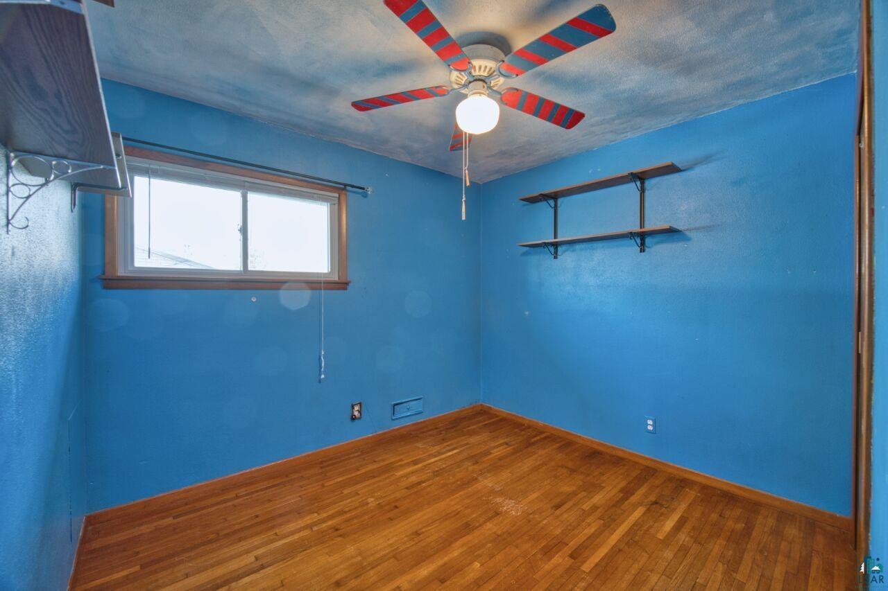 5316 Highway 110 Aurora, MN 55705 - Photo 16 of 35 Unfurnished room featuring hardwood / wood-style flooring and a ceiling fan