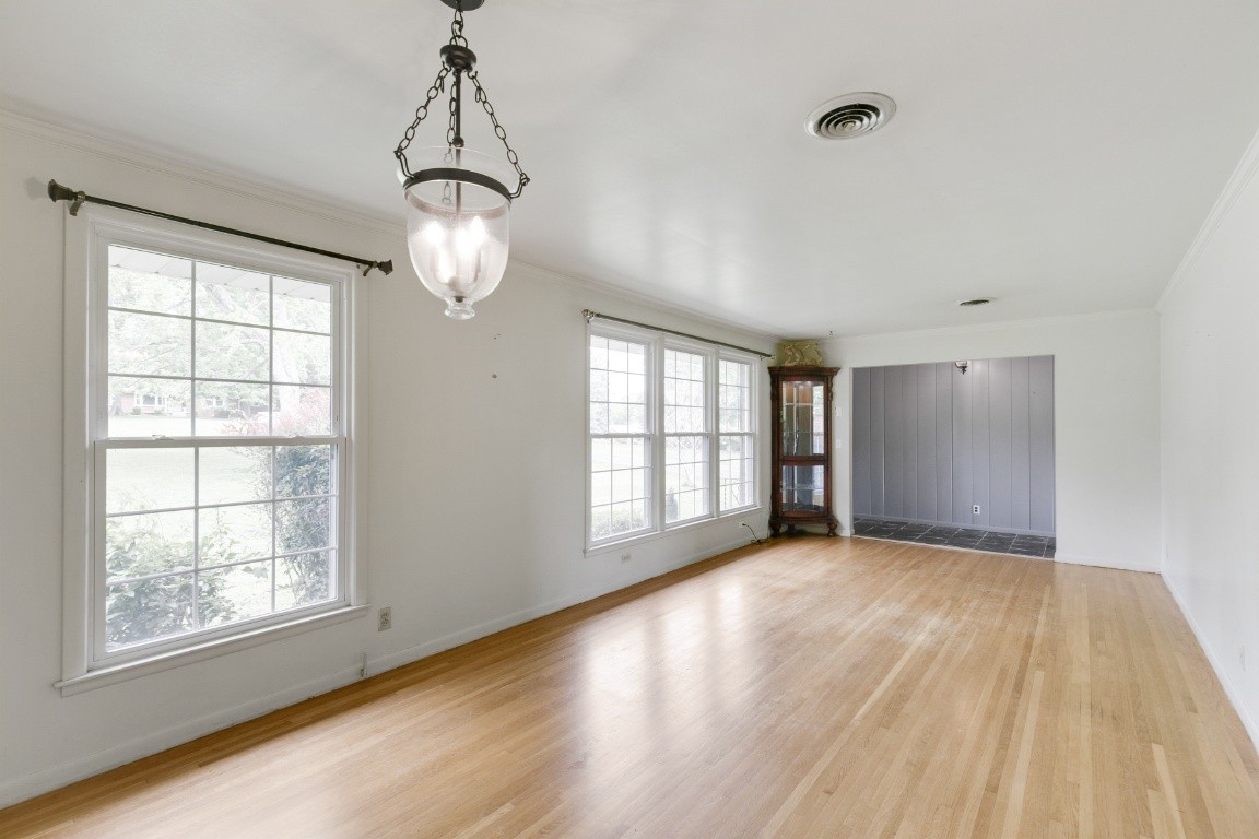 706 Ronnie Road Madison, TN 37115 - Photo 2 of 39 a view of an empty room with wooden floor and a window