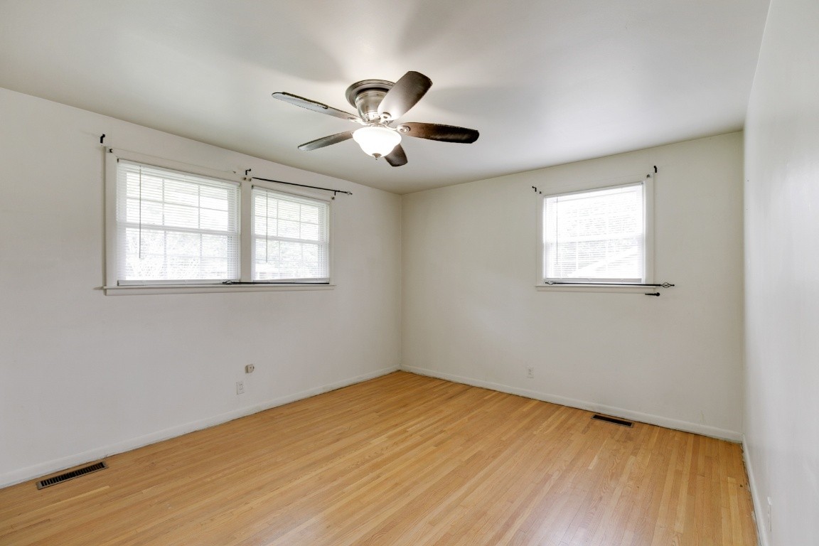 706 Ronnie Road Madison, TN 37115 - Photo 14 of 39 a view of empty room with wooden floor and fan