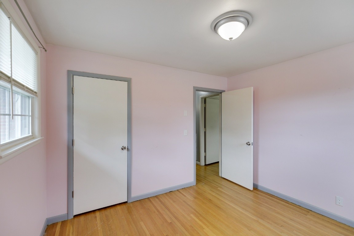 706 Ronnie Road Madison, TN 37115 - Photo 17 of 39 an empty room with wooden floor and windows