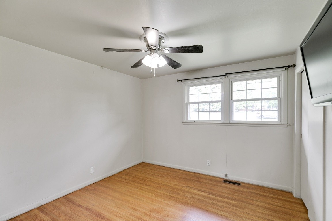 706 Ronnie Road Madison, TN 37115 - Photo 18 of 39 an empty room with wooden floor fan and windows