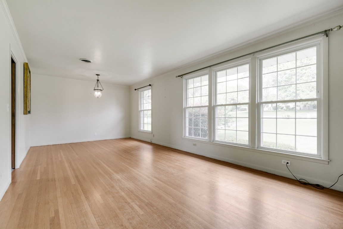706 Ronnie Road Madison, TN 37115 - Photo 3 of 39 an empty room with wooden floor and windows