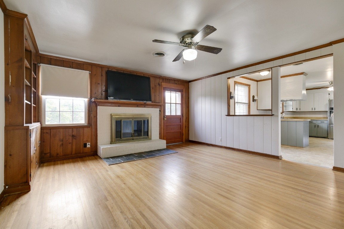 706 Ronnie Road Madison, TN 37115 - Photo 23 of 39 an empty room with wooden floor a fireplace and windows