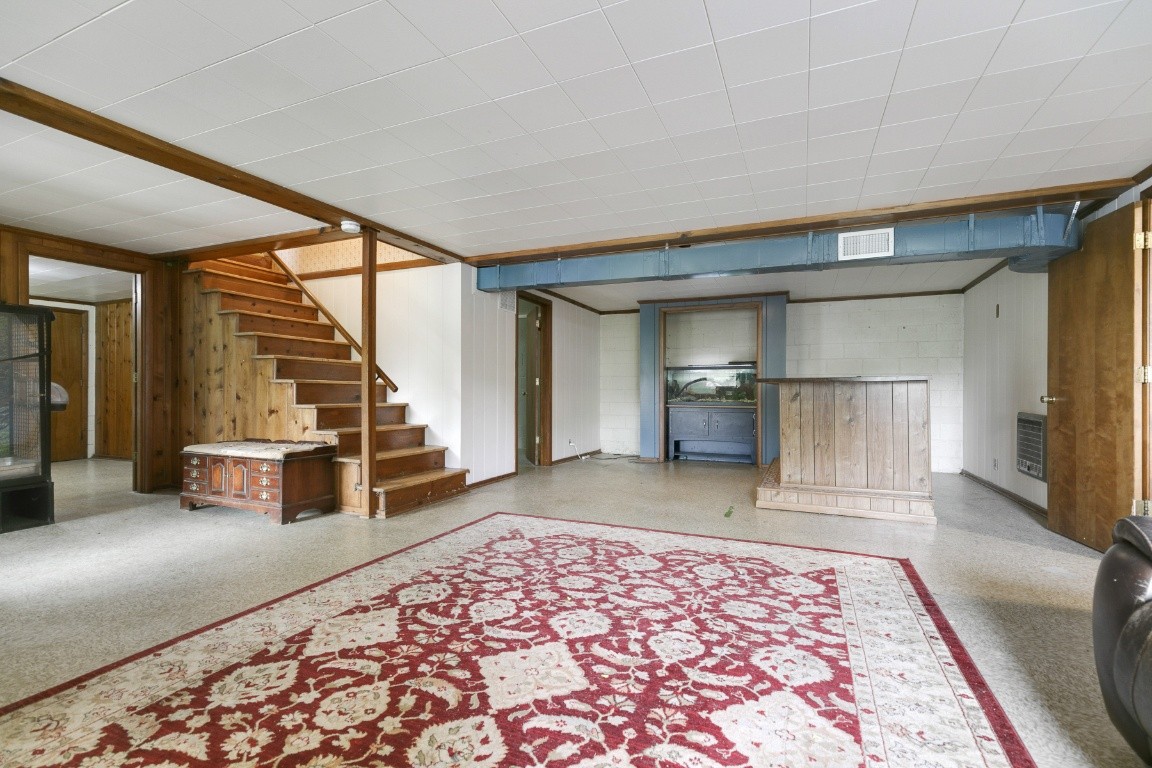 706 Ronnie Road Madison, TN 37115 - Photo 28 of 39 a view of a bedroom with wooden floor and stairs