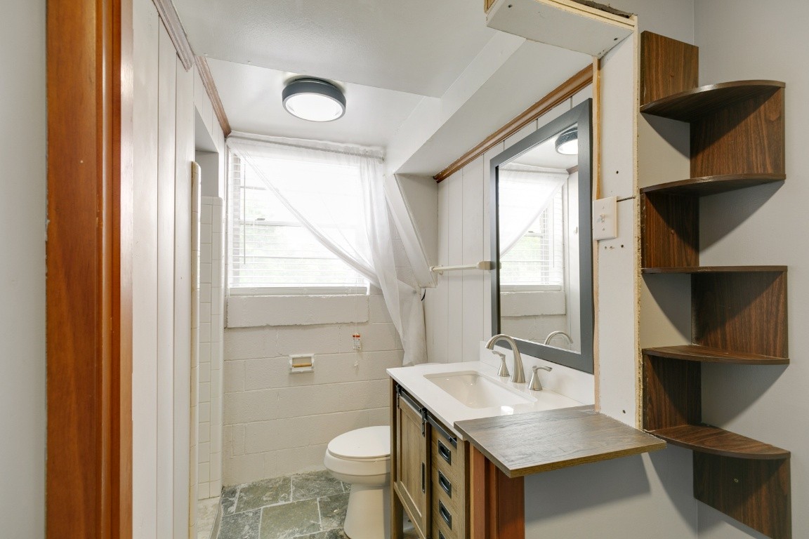 706 Ronnie Road Madison, TN 37115 - Photo 34 of 39 a bathroom with a sink toilet a mirror and window