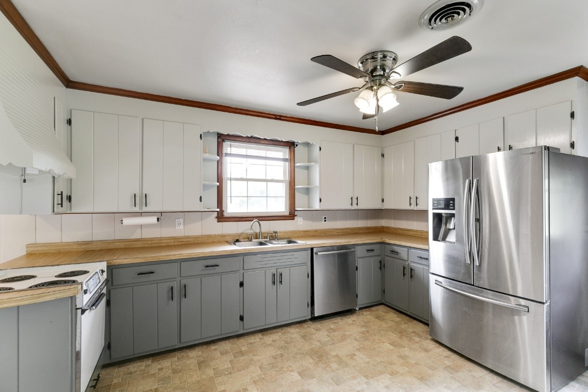 706 Ronnie Road Madison, TN 37115 - Photo 7 of 39 a kitchen with a sink stainless steel appliances and cabinets