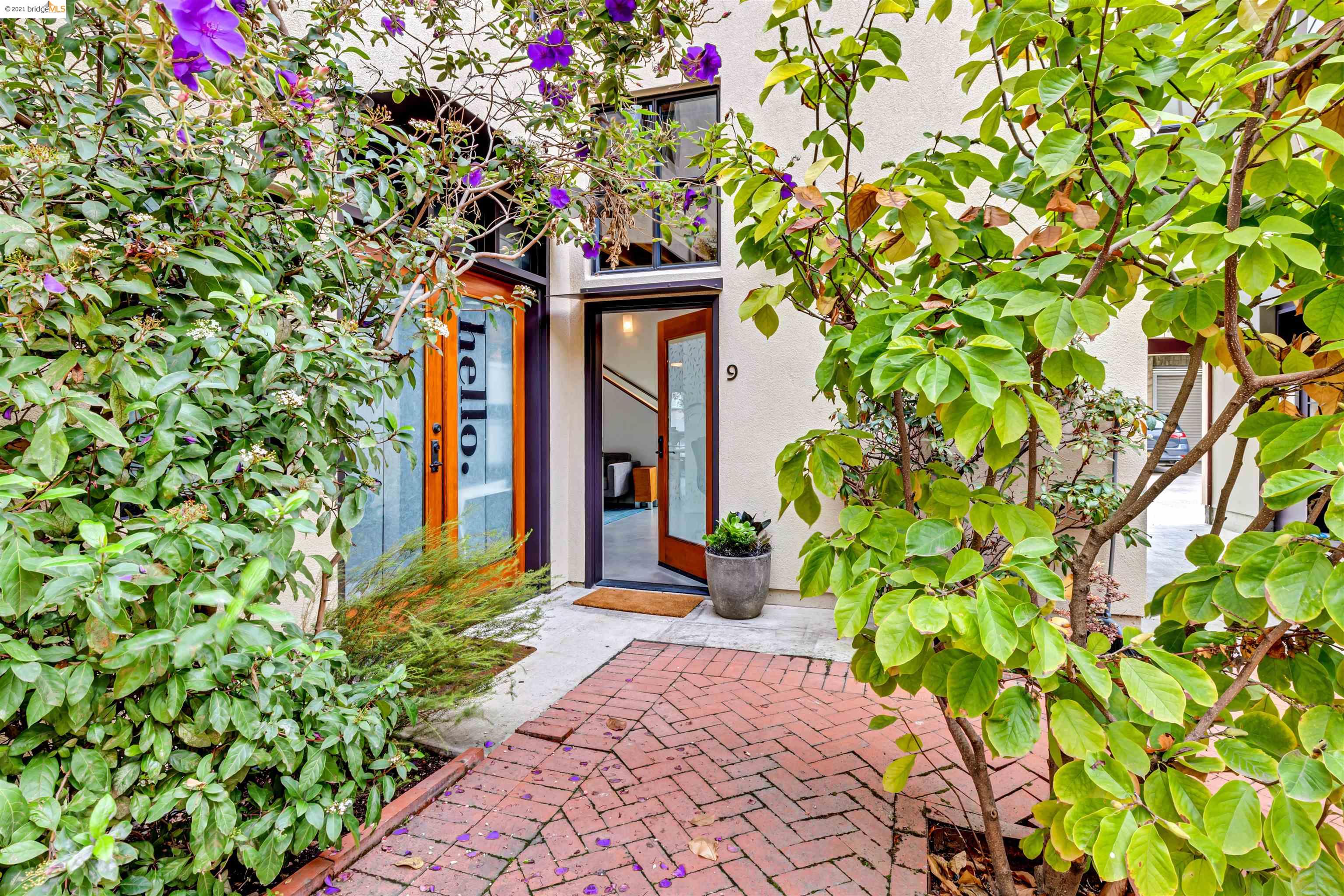 1695 15th Street, Unit 9 Oakland, CA 94607 - Photo 1 of 1 a front view of a house with a tree