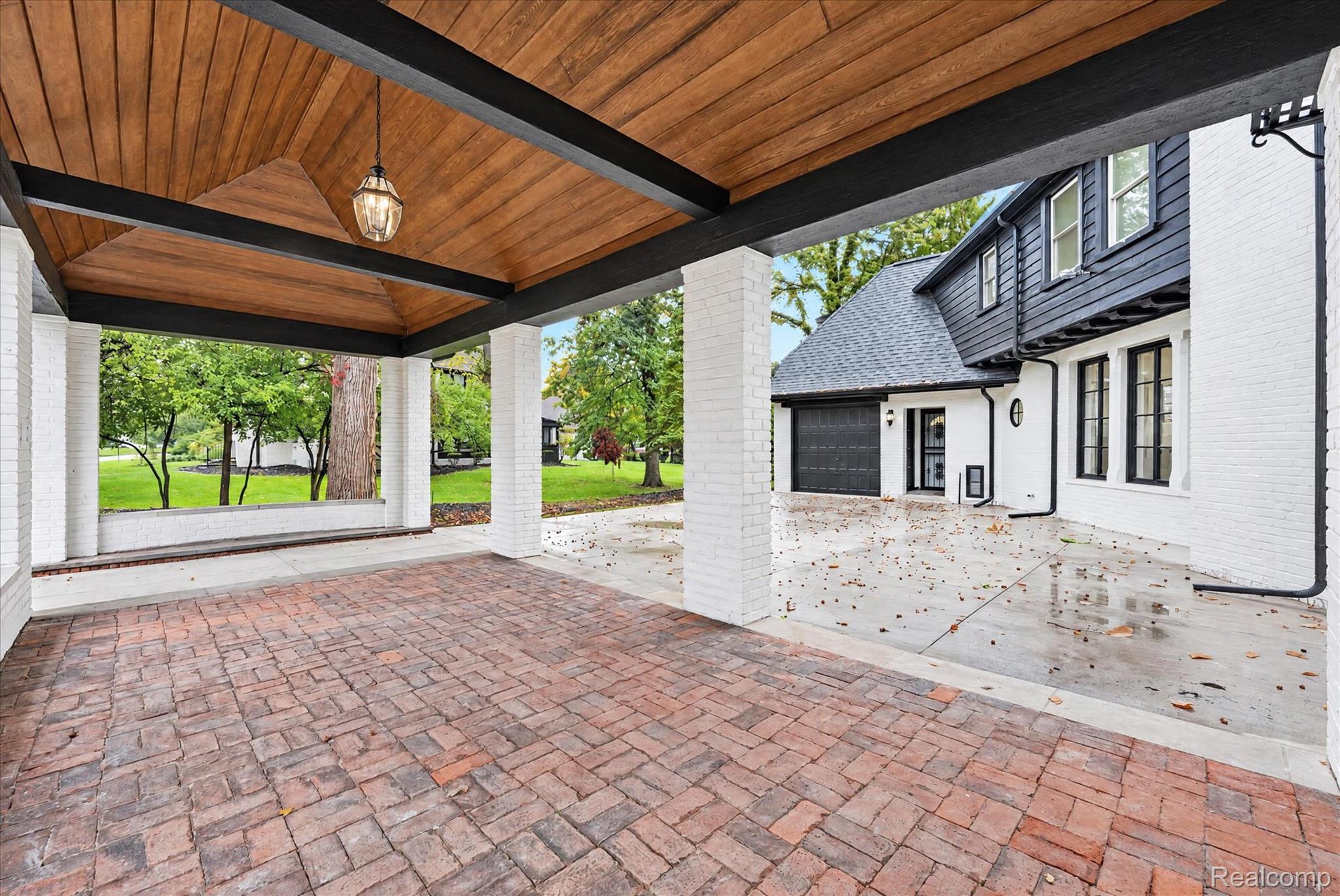 3250 Sherbourne Road Detroit, MI 48221 - Photo 32 of 36 Covered patio with brick paver flooring, wood-finish ceiling, and exposed black beams