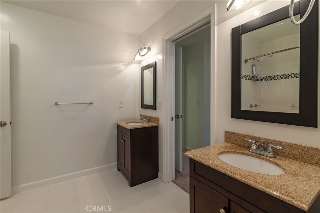 10424 Big Tujunga Canyon Road Tujunga, CA 91042 - Photo 28 of 57 a bathroom with a granite countertop sink and a mirror