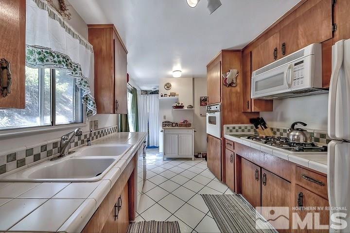 252 North Benjamin Drive Stateline, NV 89449 - Photo 10 of 19 a kitchen with stainless steel appliances a sink stove and cabinets