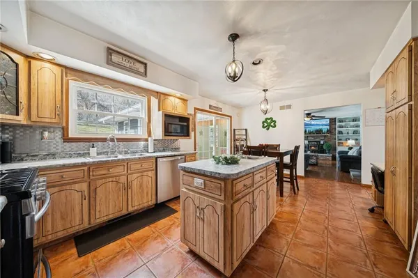 a kitchen with stainless steel appliances granite countertop a stove and a sink