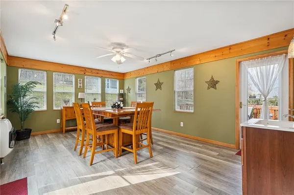 a dining room with furniture window wooden floor and a chandelier