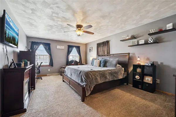 a spacious bedroom with a bed and a chandelier